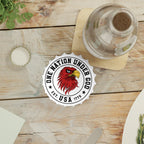 Bottle opener fridge magnet with 'One Nation Under God' logo on a wooden table with a bottle of water.