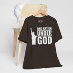 Brown t-shirt with 'One Nation Under God' graphic on a hanger against a white background