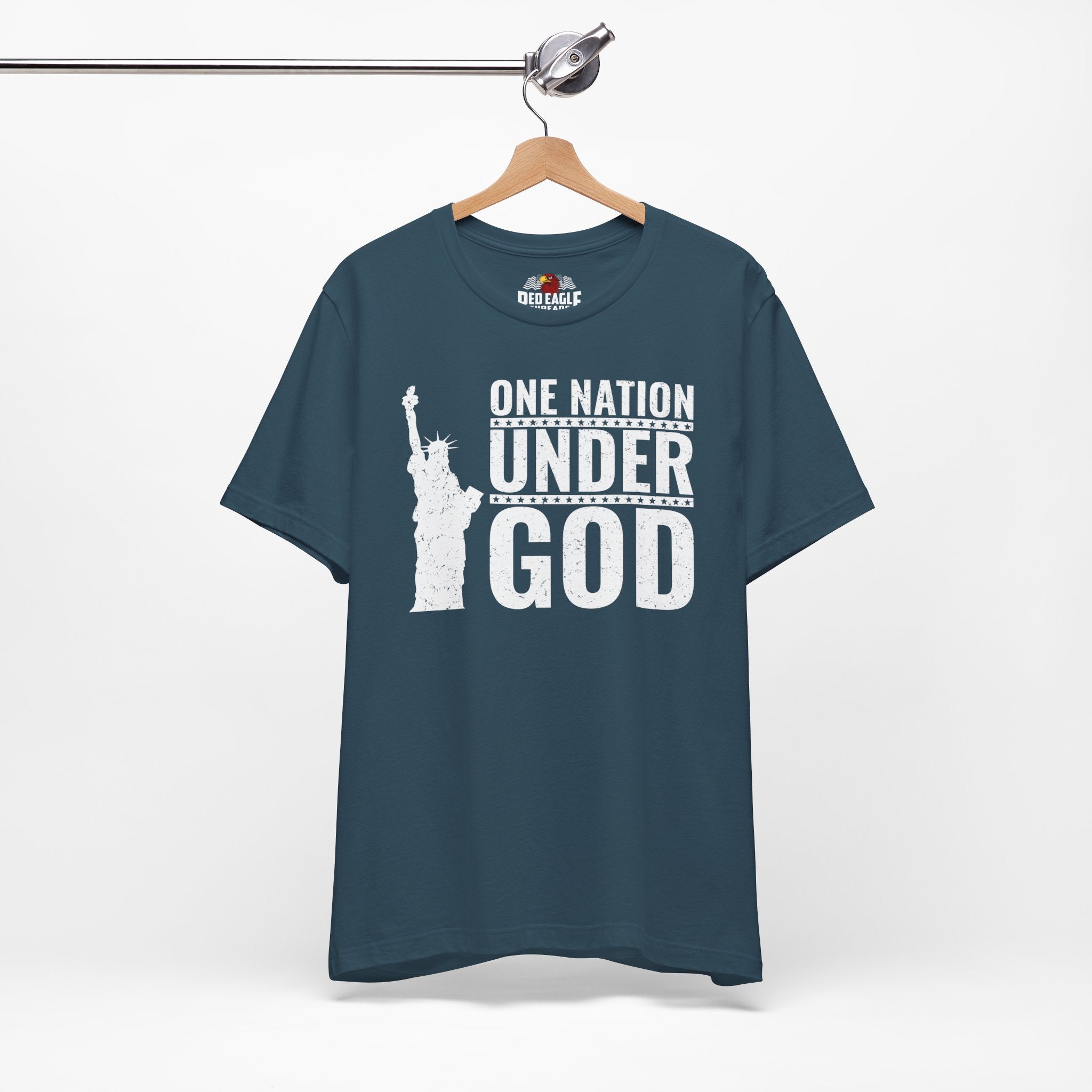 Deep teal t-shirt with 'One Nation Under God' text and Statue of Liberty graphic on a hanger.