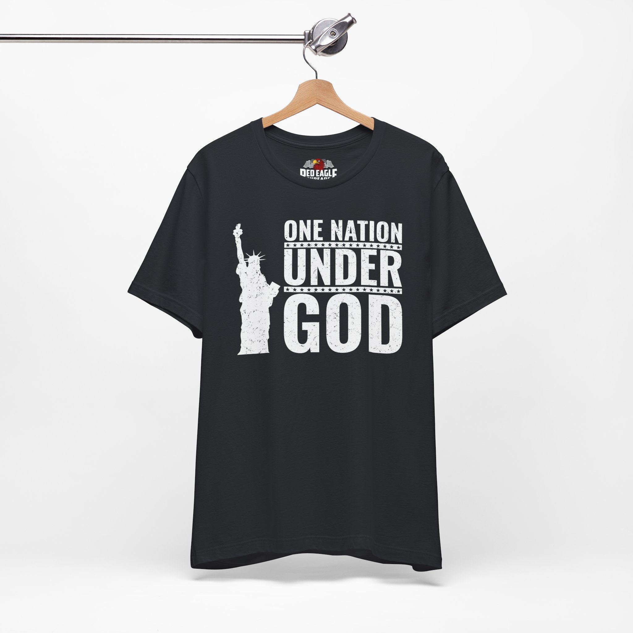 Vintage black t-shirt with 'One Nation Under God' graphic on a hanger against a white background