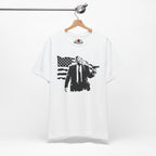 White t-shirt with black graphic design on a hanger against a white background