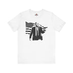 White t-shirt with black graphic design of a person holding an American flag on a white background