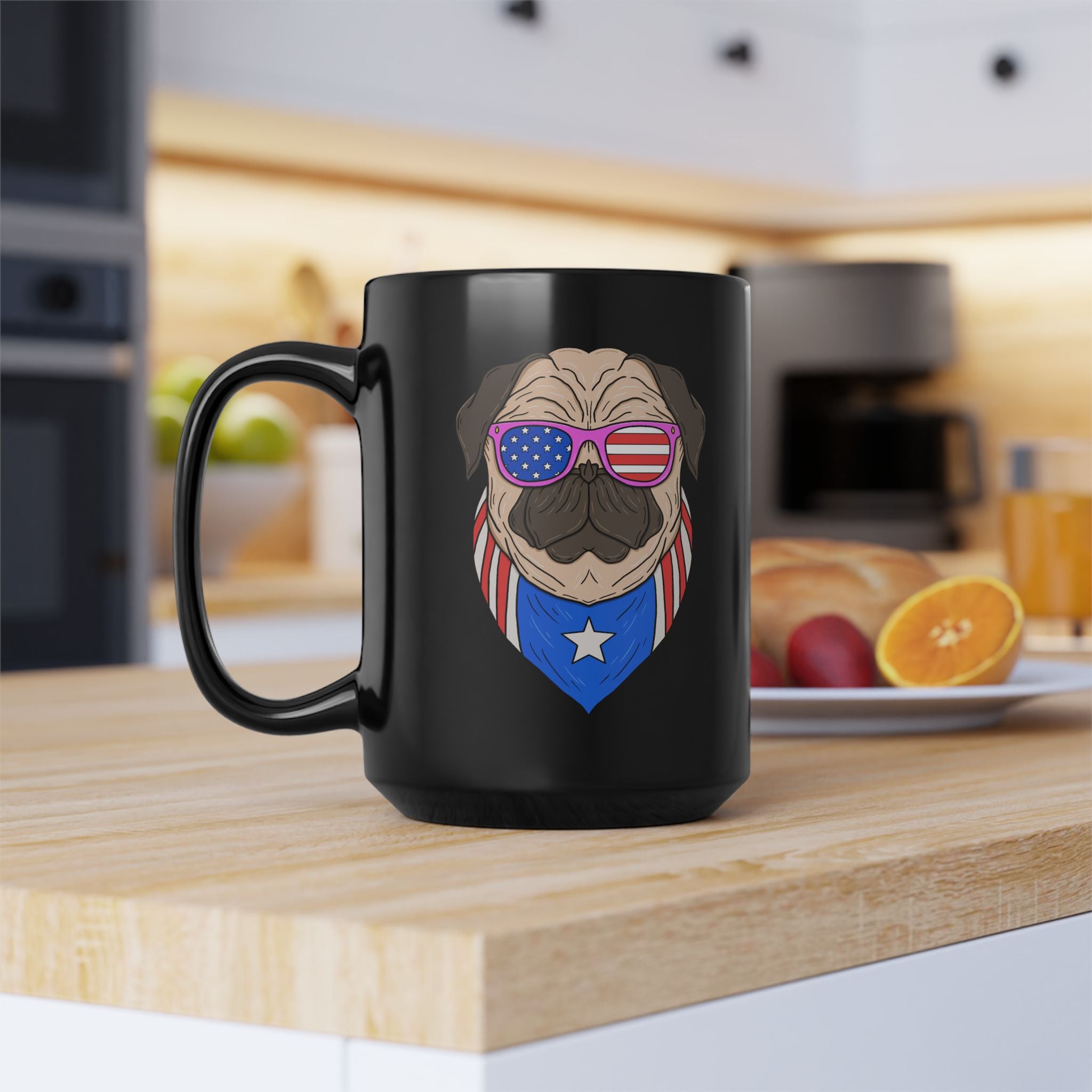 Black mug with a pug design wearing sunglasses and an American flag shirt on a kitchen counter.