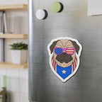 Fridge magnet of a pug wearing American flag sunglasses and a blue shirt on a metallic refrigerator.