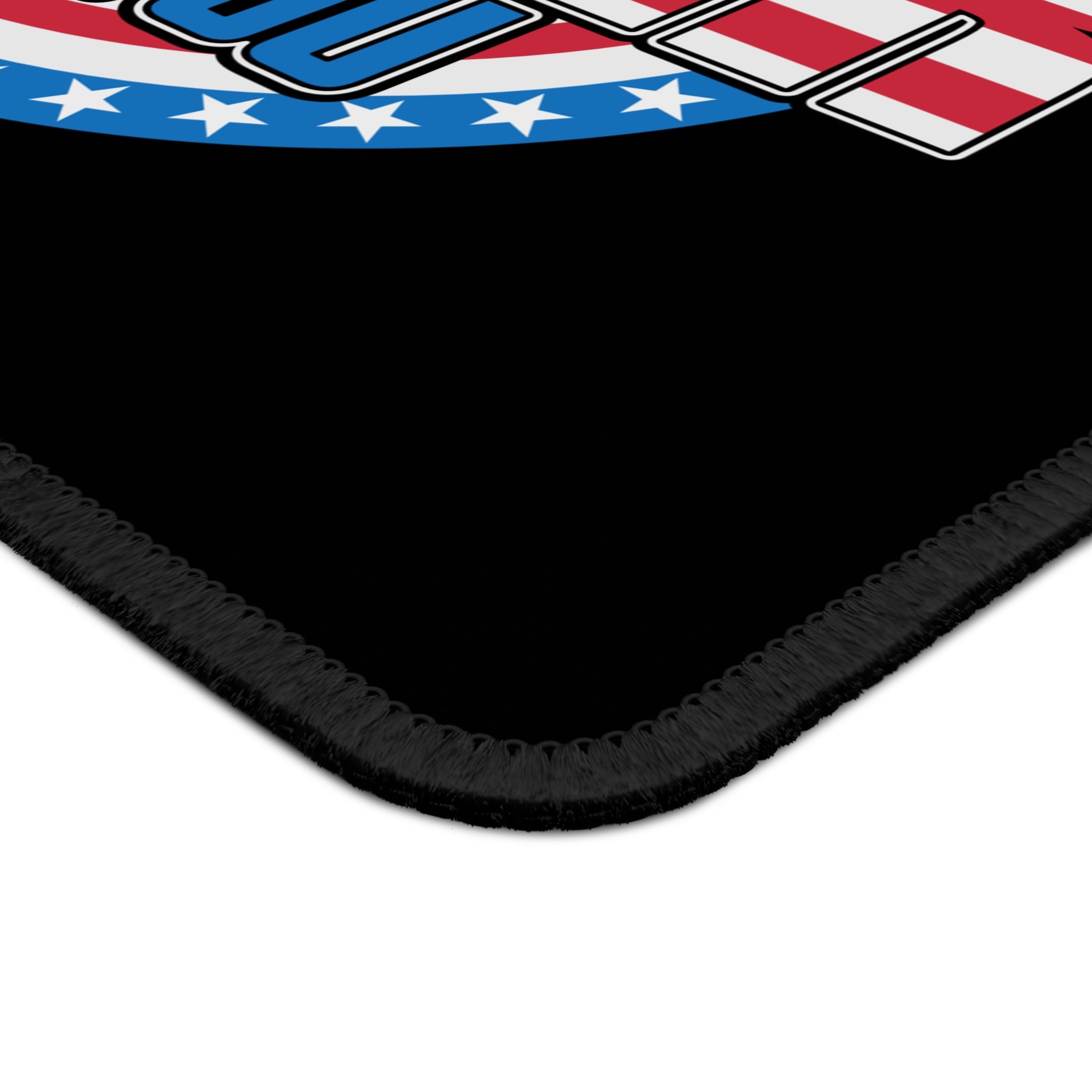 Black mat with a colorful border featuring stars and stripes design