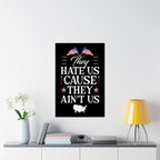 Framed poster with text and American flags on a wall above a shelf with decor items.