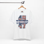 White t-shirt with '45 Trump 47' text and American flag design on a hanger.