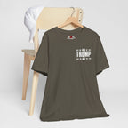 Army green t-shirt with '45 Trump 47' text on a wooden chair against a white background
