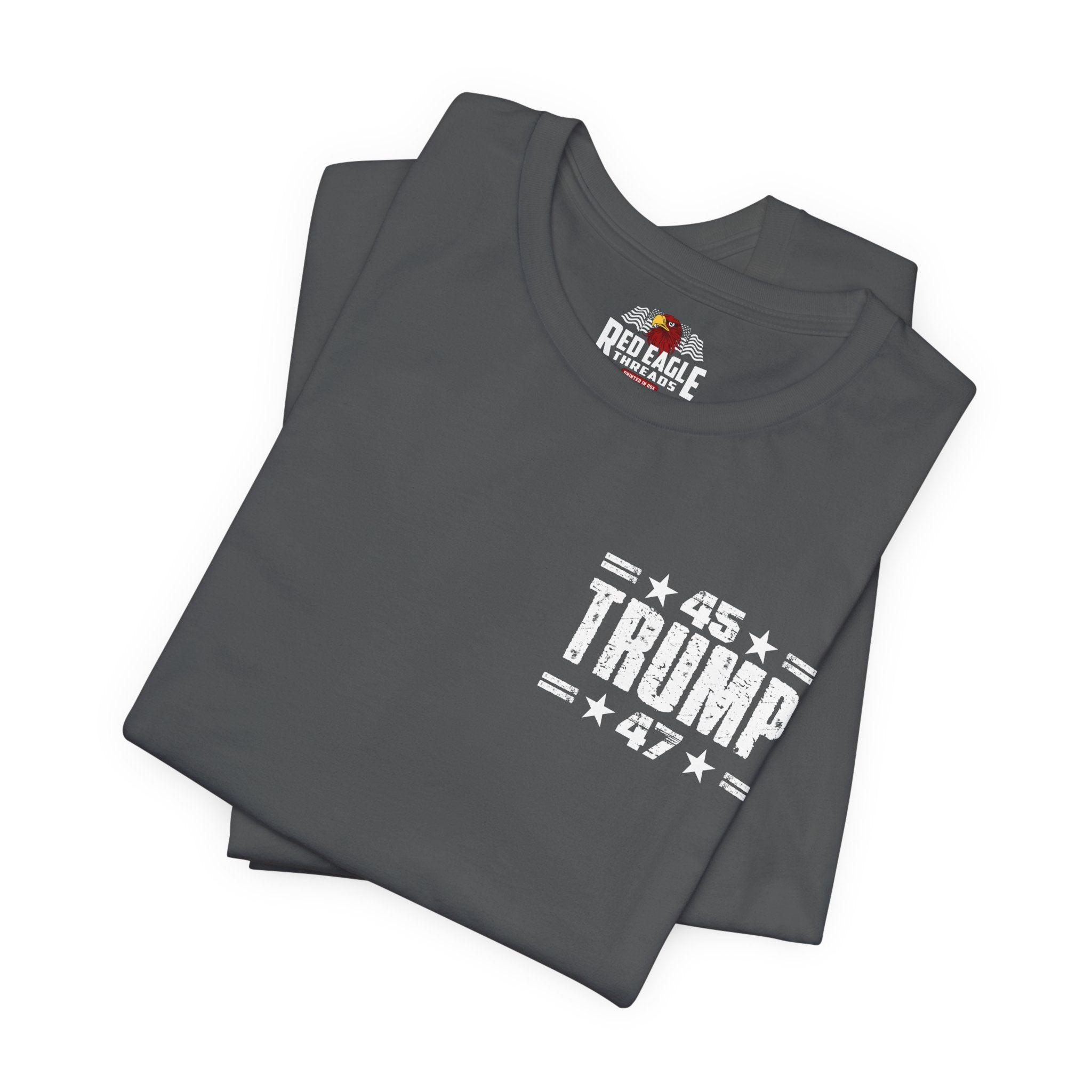 Stack of gray t-shirts with '45TRUMP 47' printed on them, featuring Red Eagle Apparel logo.