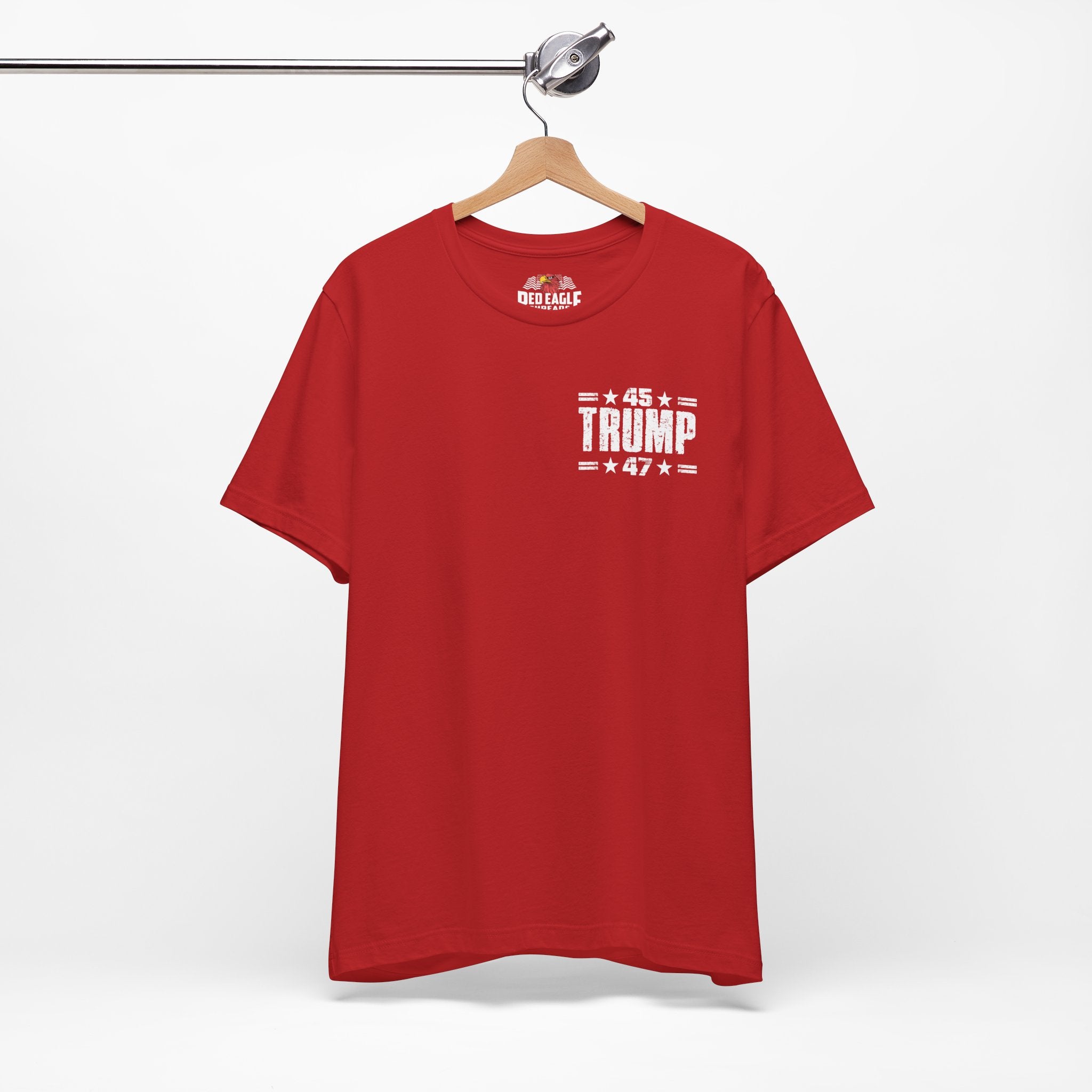 Red t-shirt with '45 Trump 47' text on a hanger against a white background