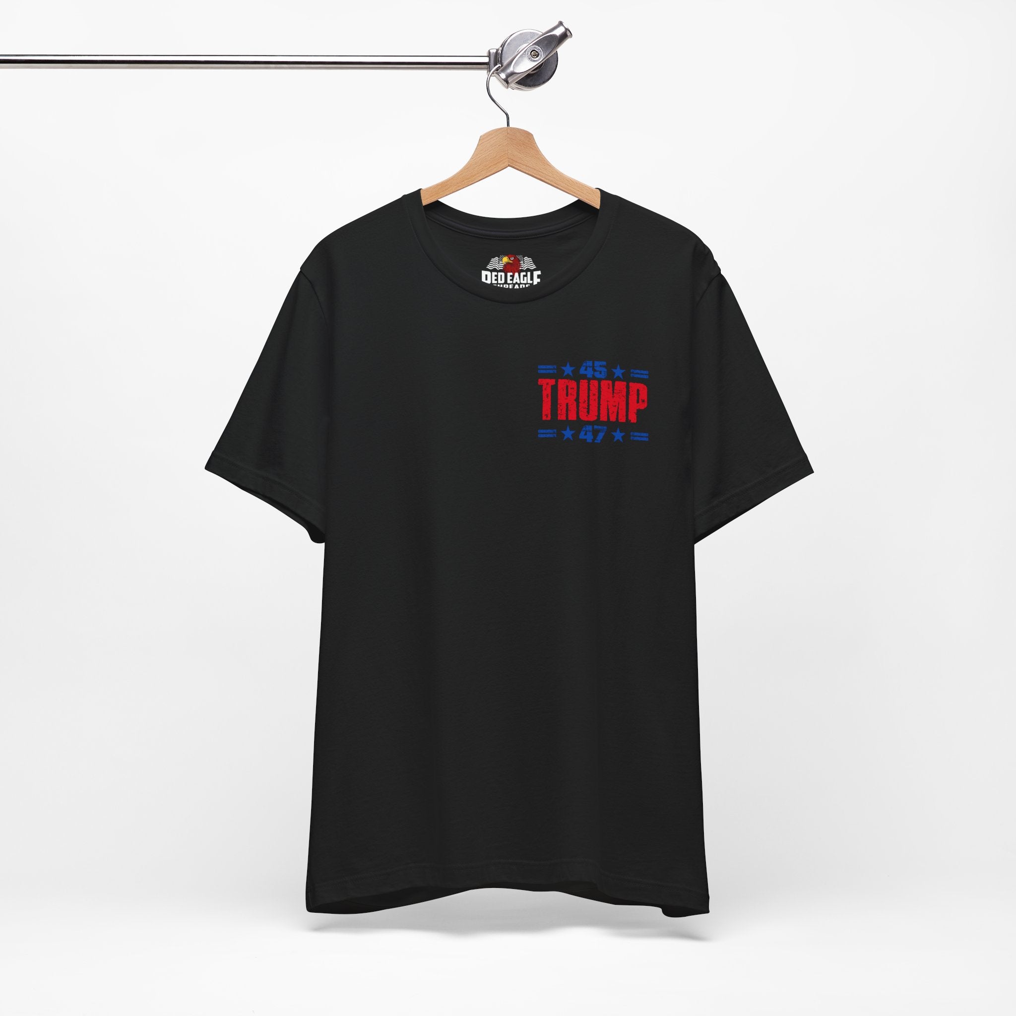 Black t-shirt with 'TRUMP' text on front on a hanger against a white background