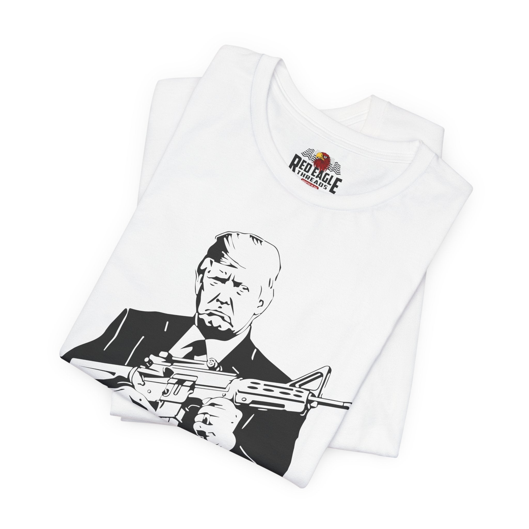 White t-shirt with graphic of a person holding a rifle and Red Eagle Firearms logo on a white background