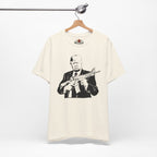 Natural t-shirt with a graphic of a man holding a rifle on a hanger against a white background.