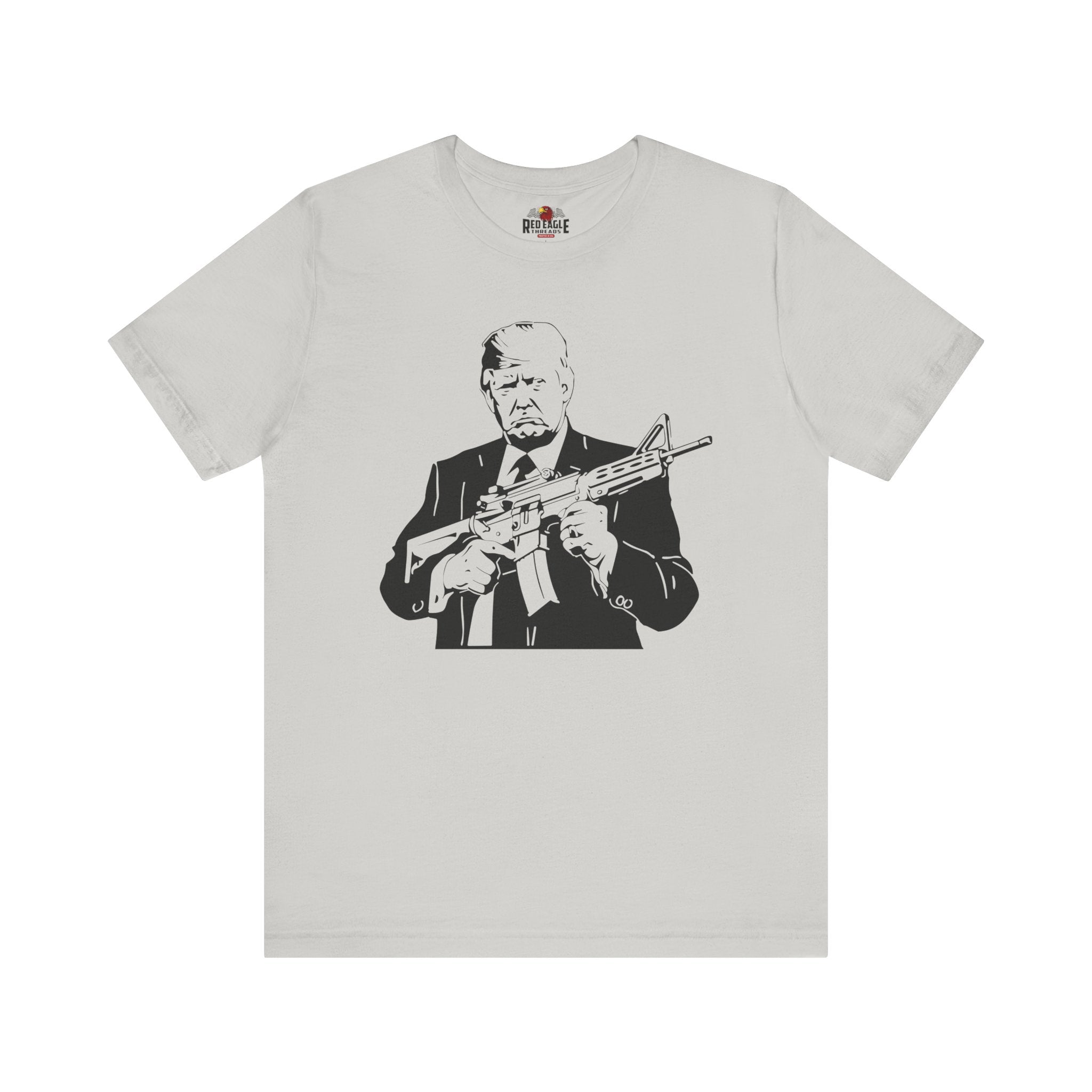 Silver t-shirt with a graphic of a person holding a rifle on a white background