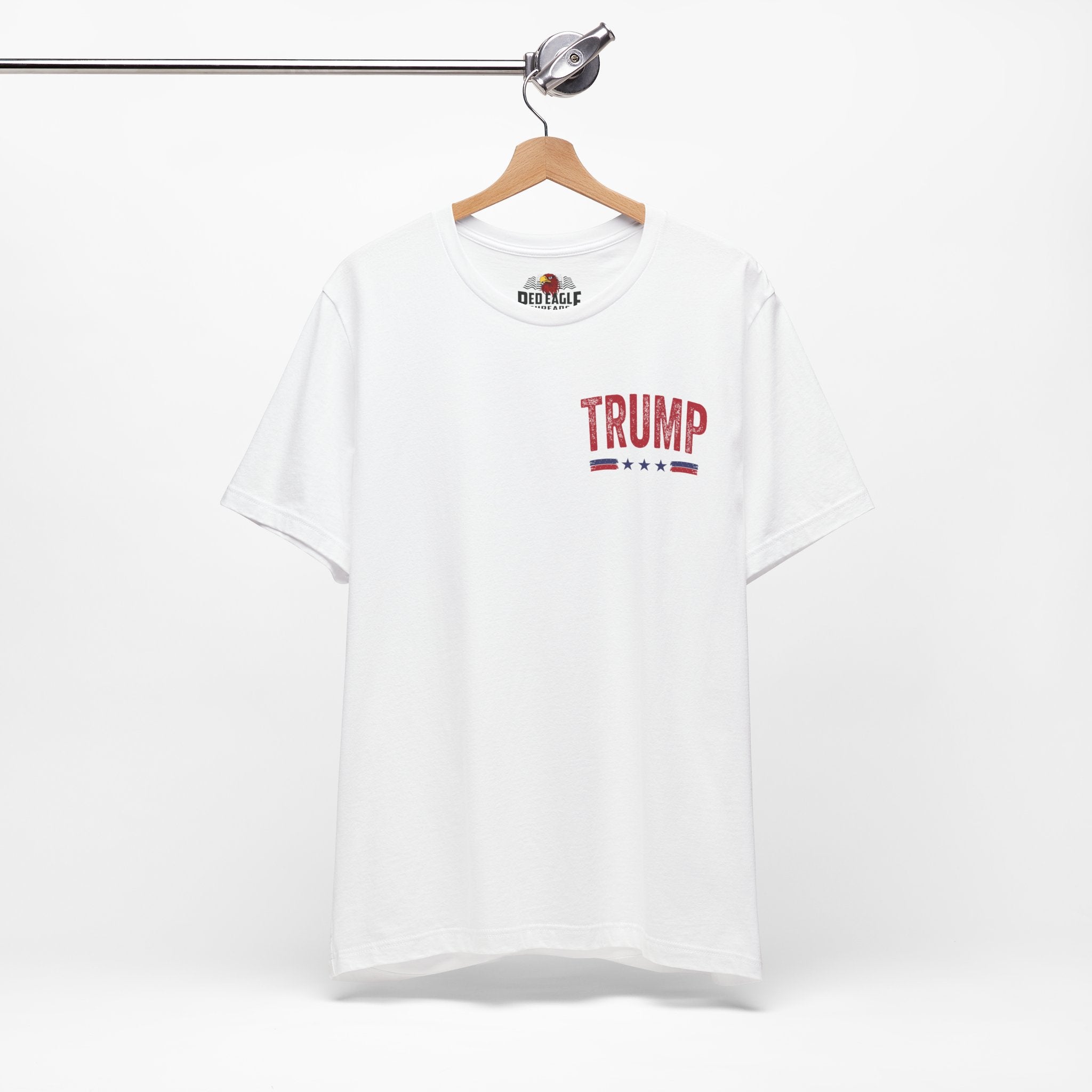White t-shirt with 'TRUMP' printed on the front, hanging on a wooden hanger against a white background.
