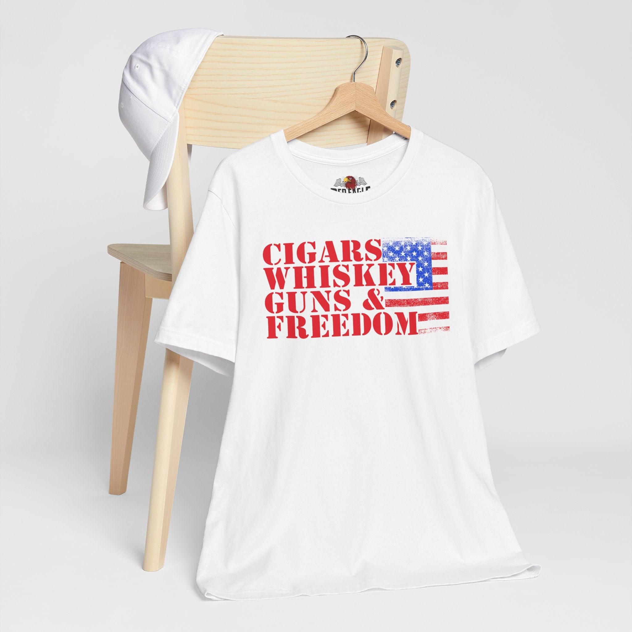 White t-shirt with text and American flag design on a chair against a white background
