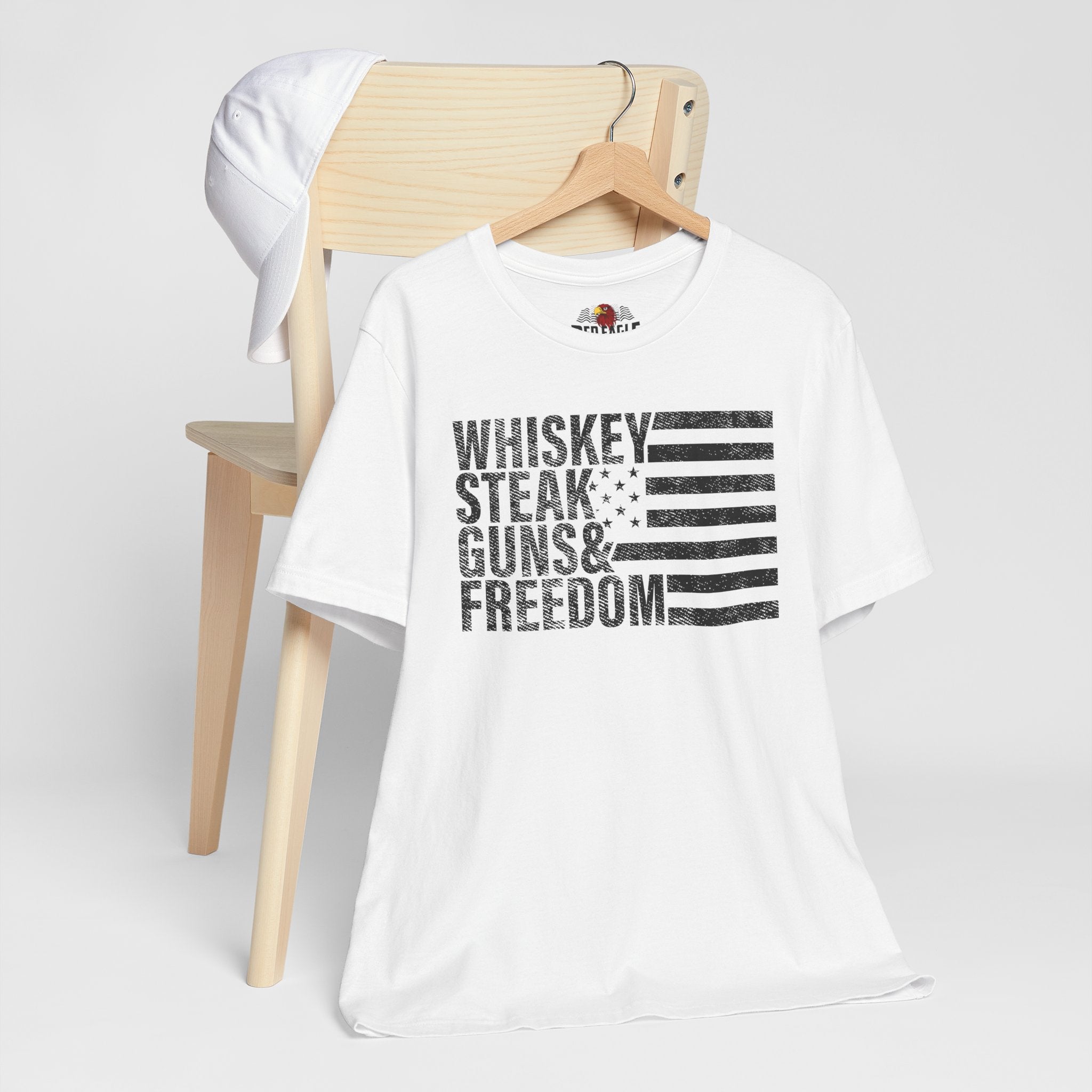 White t-shirt with text design on a wooden chair against a white background