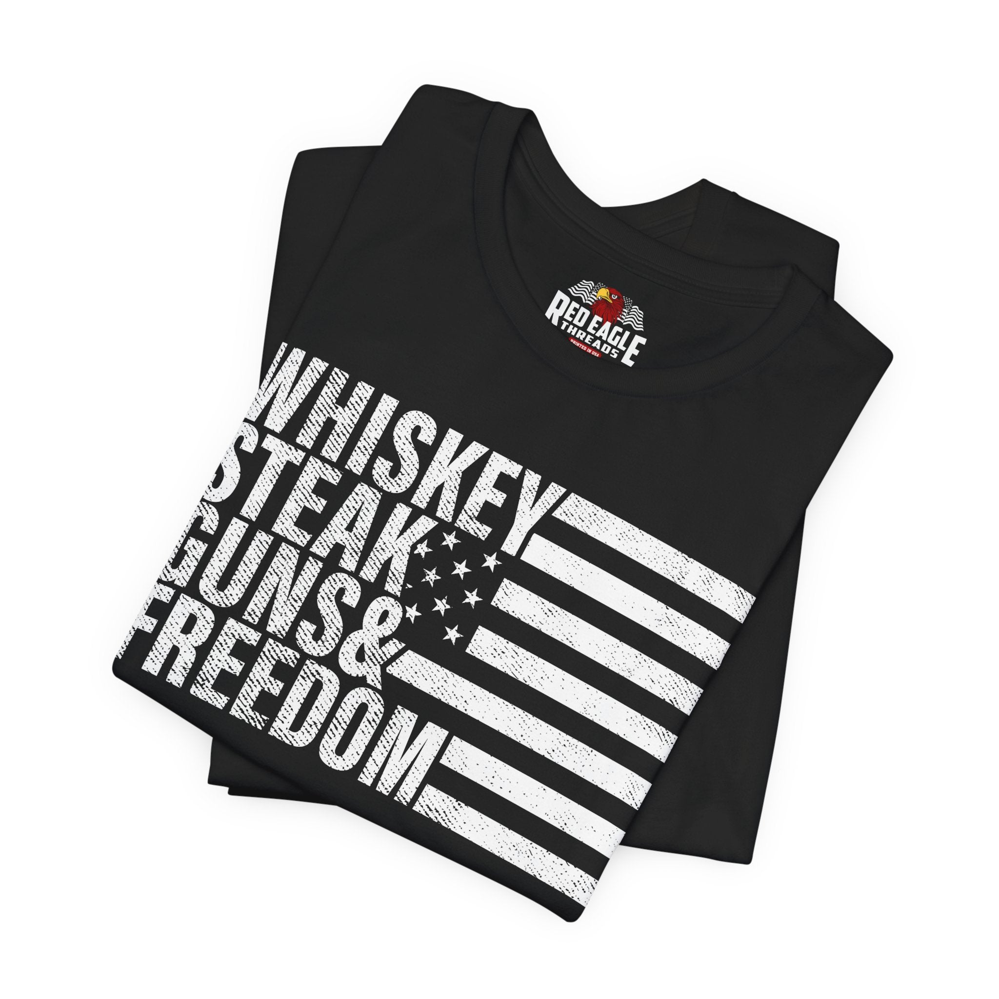 Black t-shirt with 'Whiskey Steak Guns & Freedom' text and American flag design, featuring Red Eagle Wear brand.