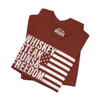 Folded rust t-shirt with 'Whiskey Steak Guns & Freedom' text and American flag design on a white background.