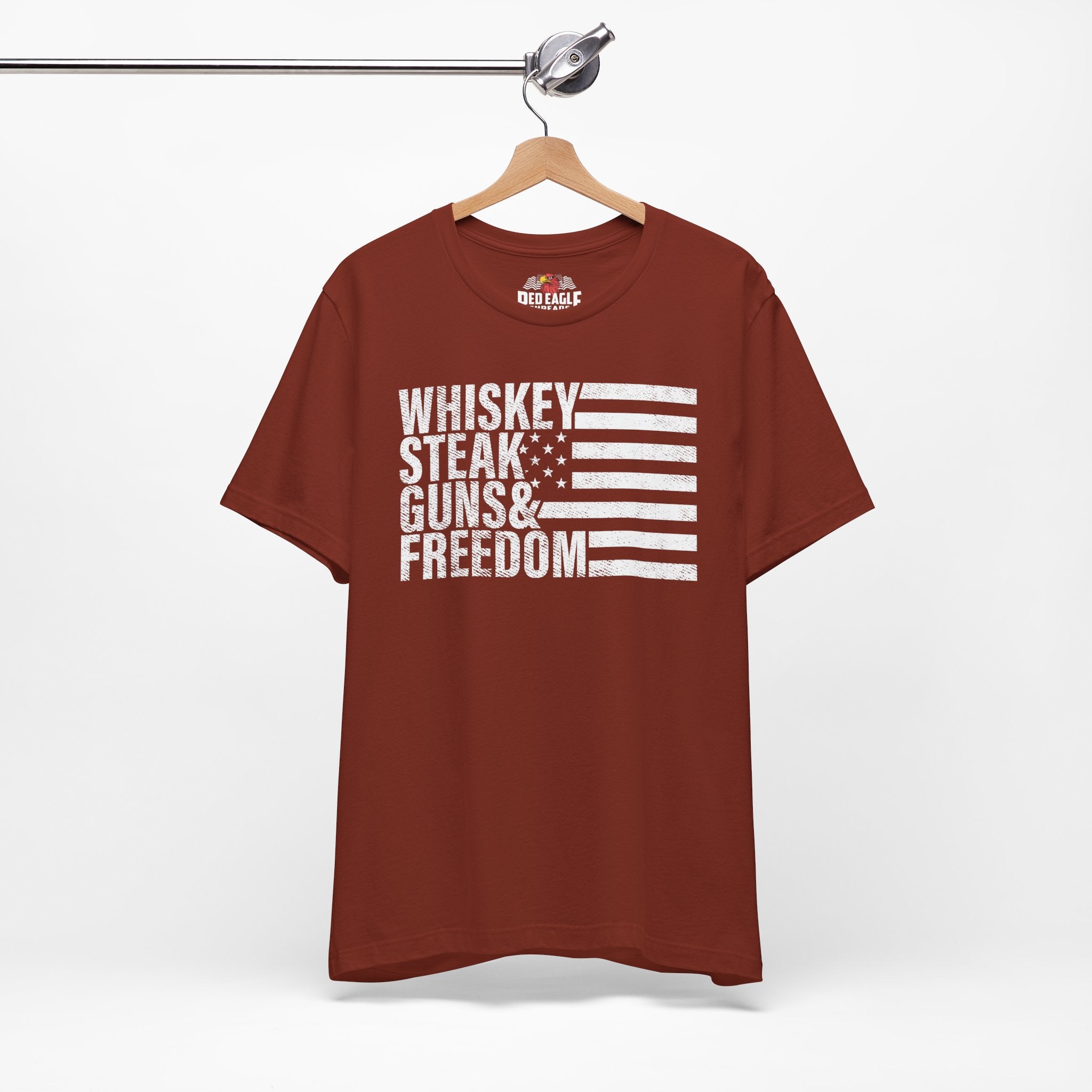 Rust t-shirt with white text and flag design on a hanger against a white background