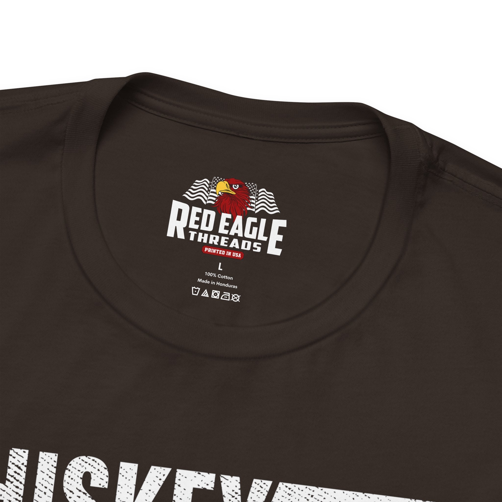 Close-up of a dark brown t-shirt with 'Red Eagle Threads' logo and text.