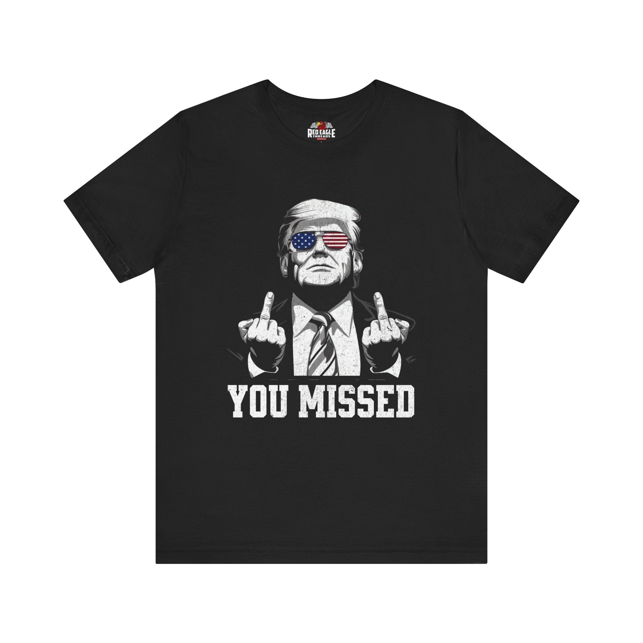 Black t-shirt with graphic of a person making an gesture and text 'YOU MISSED' on a white background