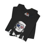 Black t-shirt with graphic design of a person wearing sunglasses with American flag design, folded on a white background.