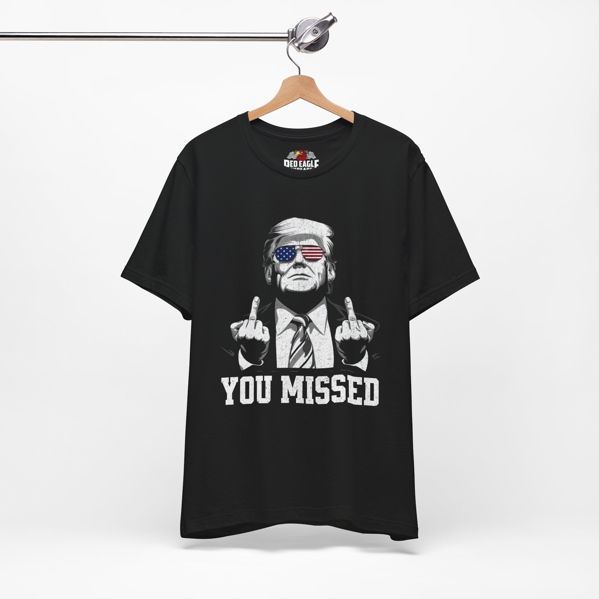 Black t-shirt with graphic design and text on a hanger against a white background